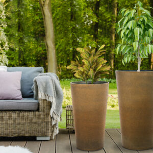 Beautiful green garden with wicker terrace furniture and trees