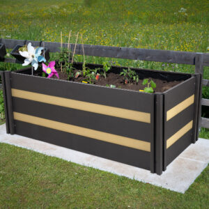 Rectangular raised bed made of wood on granite stones with small plants in the garden Rectangular raised bed made of wood on granite stones with small plants in the garden